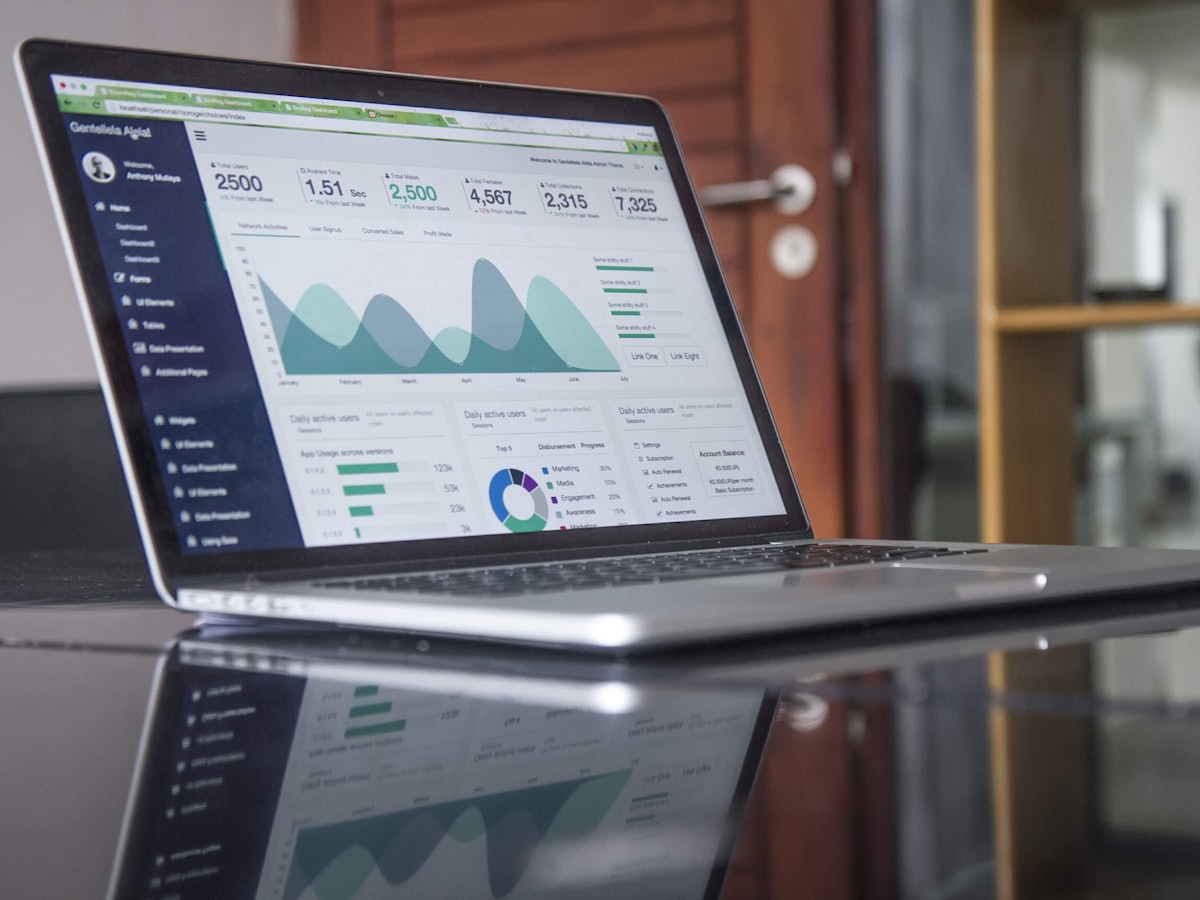 Analytics dashboard with an upward organic-traffic trend, laptop on a bright desk